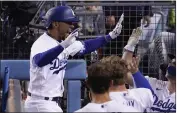  ?? MARK J. TERRILL – THE ASSOCIATED PRESS ?? The Dodgers’ Mookie Betts, left, is congratula­ted by teammates in the dugout after hitting a solo home run during the sixth inning Wednesday night.