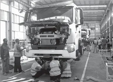  ?? PROVIDED TO CHINA DAILY ?? Sinotruk’s workers assemble a heavy-duty truck at a factory in Ethiopia on the African continent.