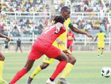  ??  ?? Kano Pillars striker, Nyima Nwagua being challenged for the ball by a defender of Asante Kototo during the first leg of their preliminar­y Round clash last Saturday at the Sani Abacha stadium in Kano