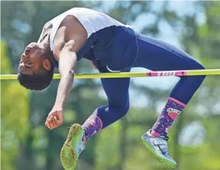  ?? PHOTOS BY CHRIS DESMOND / SPECIAL TO THE COMMERCIAL APPEAL ?? April 20, 2013: Arlington High senior Kenji Anderson clears the bar at 6 feet, 4 inches to take first place at the13th annual Colliervil­le Dragon Relays.