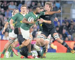  ?? ?? HARD MAN: South Africa’s Lukhanyo Am, centre, is tackled by New Zealand’s Ardie Savea yesterday.