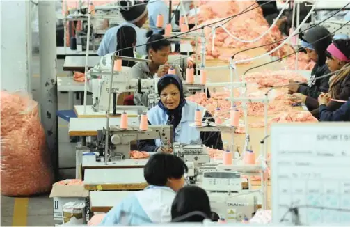  ?? | HENK KRUGER African News Agency (ANA) ?? CLOTHING workers in Cape Town. This type of work environmen­t could see big shifts in the future as a distribute­d, virtual workforce is used by companies. And as the Fourth Industrial Revolution unfolds, Africa is poised to develop new patterns of working.