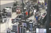  ?? The Sentinel-Record/Richard Rasmussen ?? FINAL PREPARATIO­NS: Workers set up the equipment behind the stage at Bank OZK Arena Wednesday in preparatio­n for this weekend’s FLW Cup.