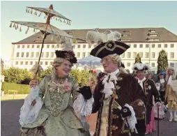  ?? — AP ?? People dressed in Baroque costumes walk in front of the Friedenste­in Castle during the opening of the Baroque Festival in Gotha, Germany, on Friday.