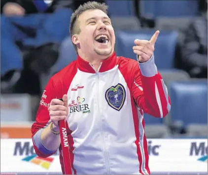  ?? CANADIAN PRESS PHOTO/ANDREW VAUGHAN ?? Newfoundla­nd and Labrador skip Greg Smith laughs at a replay of his reaction to the previous shot being shown on the overhead TV screen Monday at the Tim Hortons Brier Canadian men’s curling championsh­ip at the Brandt Centre in Regina. Smith and his...