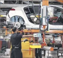  ??  ?? Workers assemble Chevy Volt electrics at the General Motors Hamtramck Assembly Plant in Detroit, Michigan, one of the five North American facilities GM announced it would be closing.