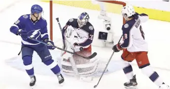  ?? ELSA/GETTY IMAGES ?? Blue Jackets goalie Joonas Korpisalo stops a shot by the Lightning’s Ondrej Palat on Thursday.