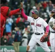  ?? MICHAEL DWYER — THE ASSOCIATED PRESS ?? Mookie Betts, center, Jackie Bradley Jr., second from right, and Dustin Pedroia, right, celebrate after Saturday’s win.