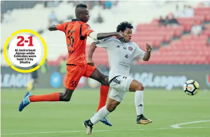  ?? Photo by Ryan Lim ?? Al Jazira beat Ajman while Emirates were held 3-3 by Dhafra Al Jazira’s Romario Da Silva (right) is challenged for the ball by Ajman’s Hassan Zahran during their Arabian Gulf League match at the Mohammed bin Zayed Stadium in Abu Dhabi, on Friday. —