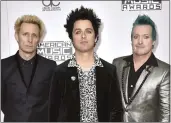  ?? PHOTO BY JORDAN STRAUSS — INVISION — AP ?? Mike Dirnt, left, Billie Joe Armstrong and Tre Cool of Green Day arrive at the American Music Awards in 2016. The group will play a show in San Francisco on Tuesday.