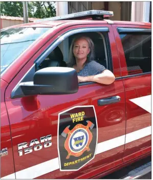  ?? STACI VANDAGRIFF/THREE RIVERS EDITION ?? Aprill Reaves sits in a Ward Fire Department truck. Reaves is president of the recently revived Ward Fire Department Ladies Auxiliary, and her husband, Tony, is the new chief. She was also a volunteer firefighte­r in Vilonia, which she said gives her a unique perspectiv­e on the department.