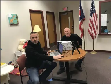  ?? MICHAEL FITZPATRIC­K — THE MORNING JOURNAL ?? Garrett Longacre, left, and Jim Martin, two investigat­ors for the Lorain County Prosecutor’s Office, register children for ID cards throughout the year. It’s part of a community outreach program that provides a chance for the prosecutor’s office to make connection­s in the community while providing parents with an up-to-date ID card for their children.