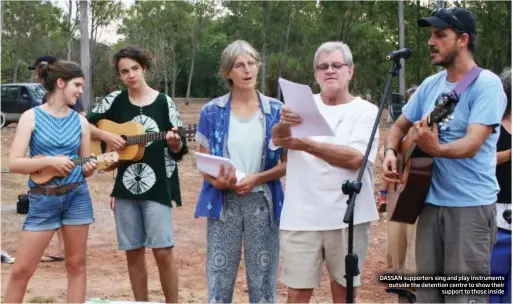  ?? DASSAN supporters sing and play instrument­s outside the detention centre to show their
support to those inside ??