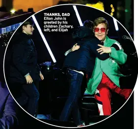  ?? ?? THANKS, DAD Elton John is greeted by his children Zachary, left, and Elijah