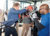  ??  ?? Stress reliever: Prince Harry launching the Heads Together campaign to end the stigma around mental health with three-time world champion Duke Mckenzie