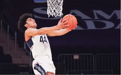  ?? Porter Binks / Getty Images ?? UConn’s Andre Jackson goes up for a dunk against DePaul during the Big East quarterfin­als on March 11 in New York.