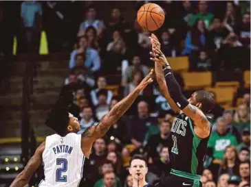  ?? REUTERS PIC ?? Boston Celtics guard Kyrie Irving (right) shoots over Orlando Magic guard Elfrid Payton during their NBA game on Sunday.