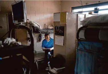  ?? Jae C. Hong/Associated Press photos ?? Joseph Sena reads at Valley State Prison in Chowchilla on Nov. 4, 2022. Sena, who killed a man, has taken courses in poetry and mental health and other topics, hoping to be seen as fit for parole.