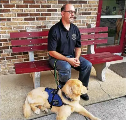  ?? DONNA ROVINS — DIGITAL FIRST MEDIA ?? Aaron Durso, Birdsboro Borough manager sits outside borough hall Aug. 15with his new service dog, Dexter. Durso, who experience­s frequent seizures, has been raising money for the past 8months to obtain a seizure response dog. Dexter will be Durso’s...