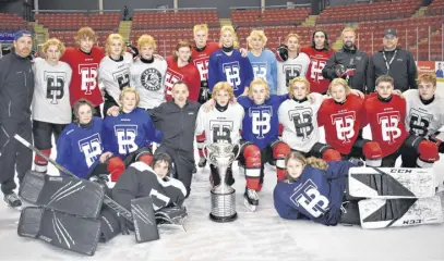  ?? RICHARD MACKENZIE ?? Truro Major U-15 players and coaches gather around the Allan Cup following a recent practice. The historic trophy was back in Truro to help celebrate the 25th anniversar­y of the Truro TSN Bearcats capturing the national title; a team which featured among its cast of stars Truro’s Sandy Mackenzie (kneeling) who is an assistant coach with the U-15 Major Bearcats. The Bearcats are hosting the provincial­s from Thursday to Sunday at the RECC.