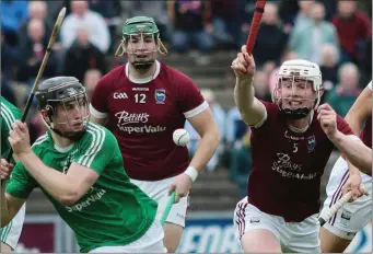  ??  ?? Seán Doyle of Naomh Eanna clears his lines under pressure from Aaron Maddock (St. Martin’s).