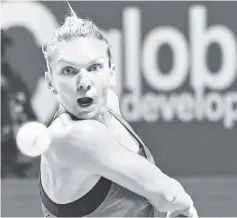  ??  ?? Simona Halep of Romania hits a return against Caroline Garcia of France during the WTA Finals tennis tournament in Singapore. - AFP photo