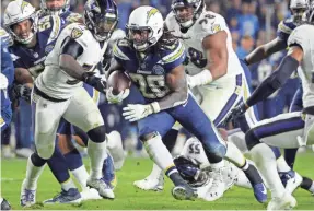  ?? JAKE ROTH/USA TODAY SPORTS ?? A wild-card round matchup to watch is Chargers running back Melvin Gordon (28) being chased by the Ravens’ C.J. Mosley (57).