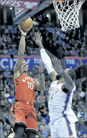  ??  ?? Raptors’ DeMar DeRozan shoots over the Thunder’s Patrick Patterson, a former teammate in Toronto, during the second quarter in Oklahoma City last night.