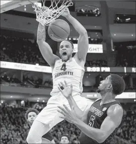  ?? Darren Hauck Associated Press ?? THEO JOHN dunks over Buffalo guard CJ Massinburg as the No. 20 Golden Eagles send the No. 14 Bulls to their first loss of the season 103-85.