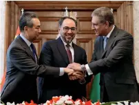  ?? Reuters ?? Foreign Minister Shah Mahmood Qureshi and his counterpar­ts Salahuddin Rabbani from Afghanista­n and Wang Yi from China shake hands after signing a memorandum of understand­ing on cooperatio­n in fighting terrorism in Kabul on Saturday. —