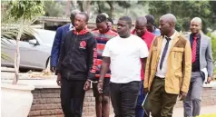  ?? ?? Six suspected armed robbers who raided a financial services company in Belgravia and got away with over US$720 676 arrive at the Harare Magistrate­s Court for their initial remand yesterday