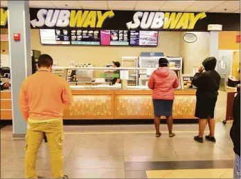  ?? Christian Abraham / Hearst Connecticu­t Media file photo ?? Customers wait for food at Subway at the Interstate 95 northbound rest plaza in Milford in 2020.