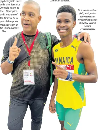  ?? CONTRIBUTE­D ?? Dr Jason Hamilton (left) with junior 800 metres star J’Voughnn Blake at the 2022 Carifta Games.