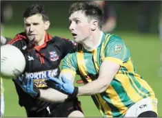  ??  ?? Donal Boyle of Clan na Gael gets his pass away as Mattock’s Adrian Reid closes in.