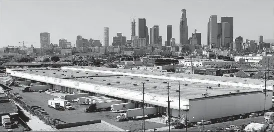  ?? Photograph­s by Mel Melcon Los Angeles Times ?? THE MIXED-USE project is proposed for a corner of the Arts District, a stretch of Alameda Street where big rigs back up to loading docks at produce warehouses.