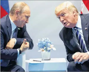  ?? AP PHOTO ?? In this July 7, 2017, file photo, President Donald Trump meets with Russian President Vladimir Putin at the G-20 Summit in Hamburg. Trump signed on Aug. 2, what he called a “seriously flawed” bill imposing new sanctions on Russia, pressured by his...