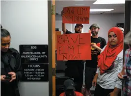  ?? CP PHOTO ?? Demonstrat­ors stand in the doorway of MP Andy Fillmore’s constituen­cy office advocating for a stay on the deportatio­n of Abdilahi Elmi to Somalia during a protest in Halifax on Tuesday.