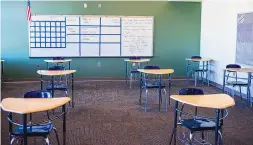  ?? ROBERTO E. ROSALES/ JOURNAL ?? Albuquerqu­e Public Schools teachers and staff are preparing classrooms for students’ return next week. Desks at Wilson Middle School are separated with as much social distancing as possible.