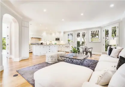  ?? PHOTOGRAPH BY AERIAL CANVAS / STAGING BY STUDIO D ?? Above: Recessed lights illuminate the family room’s flowing floor plan at 2100 Jefferson St. in the Marina District. Below: French doors open to a patio that’s ideal for outdoor dining.