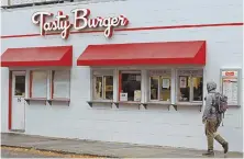  ?? STAFF PHOTO BY STUART CAHILL ?? EMBROILED: Tasty Burger, which is expanding beyond its Greater Boston locations — including one on L Street in Southie, shown — is battling Chipotle, which just launched the Tasty Made chain, saying similar logos, below, and names could confuse...