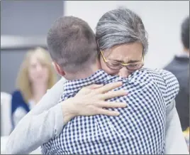  ?? CP PHOTO ?? Shelley Reuter hugs Marc Lafrance, friends and colleagues of Canadian professor Homa Hoodfar, as they celebrate her release.