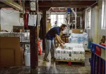  ?? ALEX ATACK / THE NEW YORK TIMES ?? Bags of flour are loaded onto a pallet at Wessex Mill in Wantage, England, on May 15. “Demand remains consistent­ly obscene,” says Emily Munsey, who runs the Wessex Mill with her father. The family business started 125 years ago.