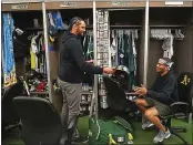  ?? ARIC CRABB – STAFF PHOTOGRAPH­ER ?? Sean Manaea, left, hands a signed helmet to clubhouse assistant Elijah Toland as the A’s clean out their lockers.