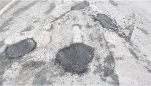  ??  ?? ●● Pothole repairs on Gladstone Street, Bacup