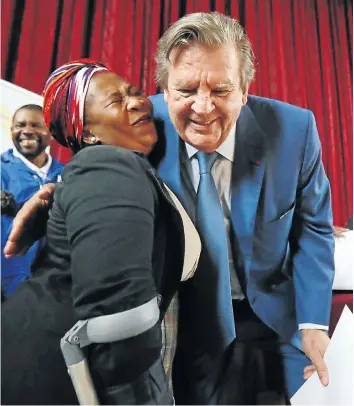  ?? Picture: Esa Alexander ?? Kayamandi homeowner Lauren Baba receives her title deed from Johann Rupert.