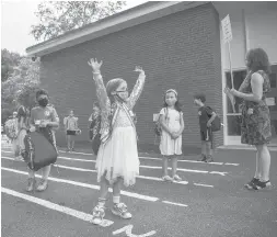  ?? COURANTFIL­E PHOTO ?? On the first day of classes, first grader Ava Callahan raises her arms with excitement while standing in line outside Bugbee Elementary School in West Hartford.