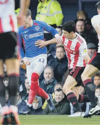  ??  ?? Luke O’Nien battles for the ball in the 2-0 defeat to Portsmouth at Fratton Park.