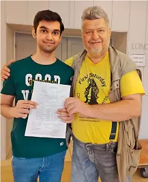  ??  ?? Raja Rithvik (left) poses after receiving his third Grand Master Norm from Lo Nagy Laszlo at the Vezerkepzo Grandmaste­r Tournament in Budapest, Hungary.