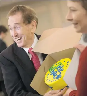  ?? MICHELLE BERG/ The Starphoeni­x ?? Bob McGrath, a longtime Telemiracl­e host, shows off a Telemiracl­e cake before receiving a Distinguis­hed Service Award on Thursday from Premier Brad Wall.