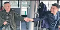  ?? LIU TING / FOR CHINA DAILY ?? Sheng Jun shakes the hand of a child with special needs on the bus on Feb 14. Sheng, a resident of Wuhan, the capital city of Hubei province, won the job of driving 40 children with special needs to and from their school. About 2,000 candidates applied...